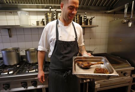 Balazs Ban, chef of the Macesz Huszar restaurant, prepares a goose plate in Budapest November 21, 2014. REUTERS/Laszlo Balogh