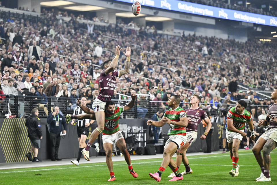 Sea Eagles Jason Saab leaps to take the ball during the opening match of the NRL between the Manly Warringah Sea Eagles and the South Sydney Rabbitohs at Allegiant Stadium in Las Vegas, Saturday, March 2, 2024. (AP Photo/David Becker)