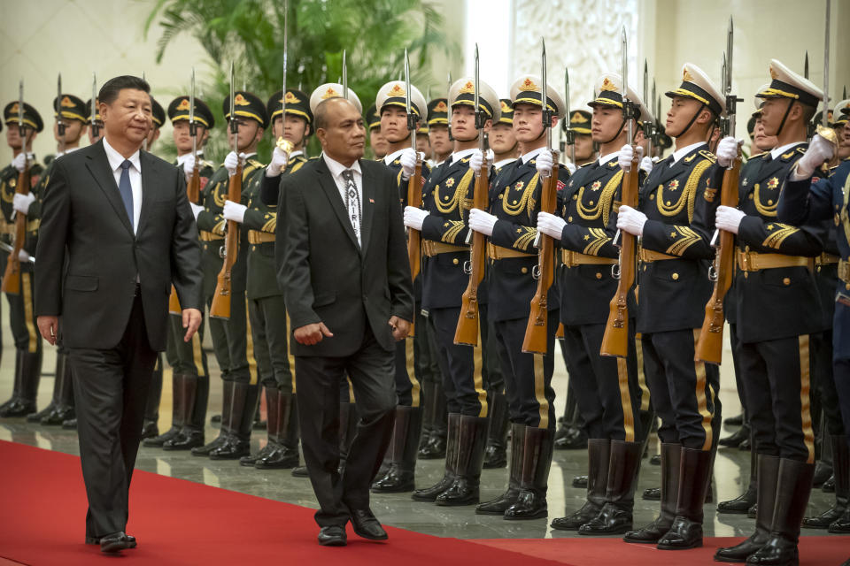 Chinese President Xi Jinping, left, and Kiribati's President Taneti Maamau review an honor guard during a welcome ceremony at the Great Hall of the People in Beijing, Monday, Jan. 6, 2020. (AP Photo/Mark Schiefelbein)