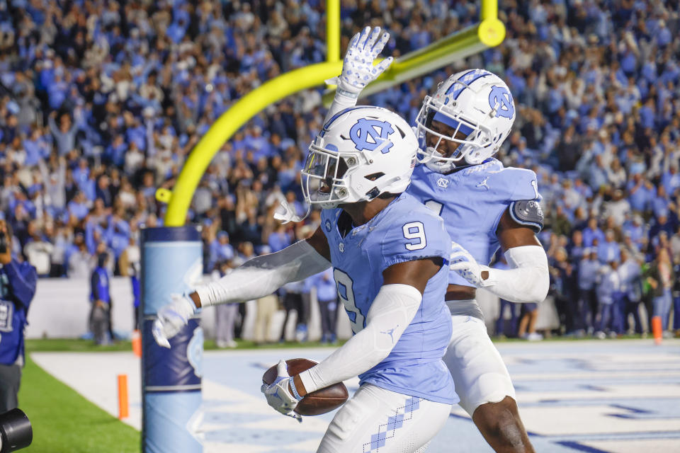 Oct 21, 2023; Chapel Hill, North Carolina, USA; North Carolina Tar Heels defensive back Armani Chatman (9) celebrates with defensive back Antavious Lane (1) after intercepting a Virginia Cavaliers pass in the end zone in the first half at Kenan Memorial Stadium. Mandatory Credit: Nell Redmond-USA TODAY Sports