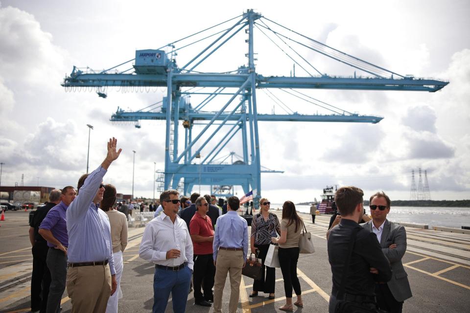 Attendees mingle on the Blount Island terminal's dock Monday as they awaited a ceremony marking the completion of the 11-mile deepening of the St. Johns River. Federal, state and local officials joined in the event that capped years of studies and several rounds of funding from all levels of government.