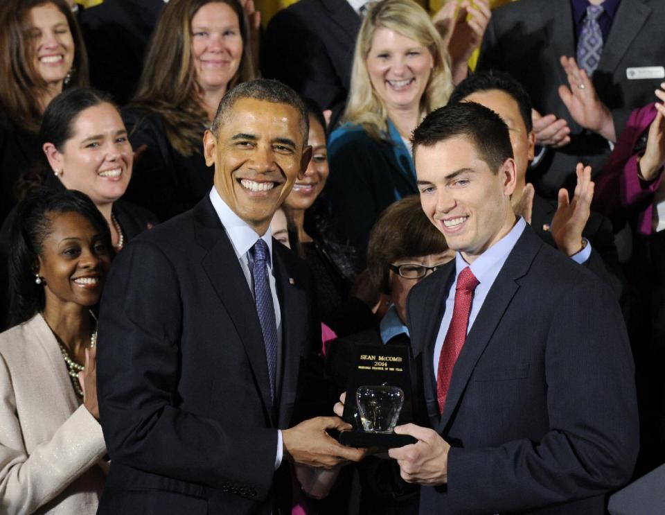 President Obama presents the 2014 National Teacher of the Year Sean McComb, a high school English teacher from Maryland who helps push students toward college, with his award, Thursday, May 1, 2014, during a ceremony to honor the 2014 National Teacher of the Year and finalists in the East Room of the White House in Washington. (AP Photo/Susan Walsh)