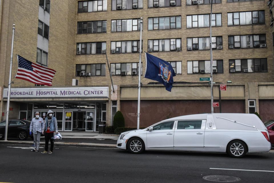 NEW YORK, NY - APRIL 27 : A white hearse stands outside the Brookdale Hospital Medical Center on April 27, 2020 in the Brooklyn borough in New York City. Although New York's daily coronavirus death toll has dropped to below 400, New York City remains the epicenter of the disease with over 12,000 deaths to date. (Photo by Stephanie Keith/Getty Images)