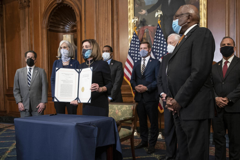 US House Speaker Nancy Pelosi, a Democrat from California, displays the articles of impeachment against President Donald Trump. Source: Getty