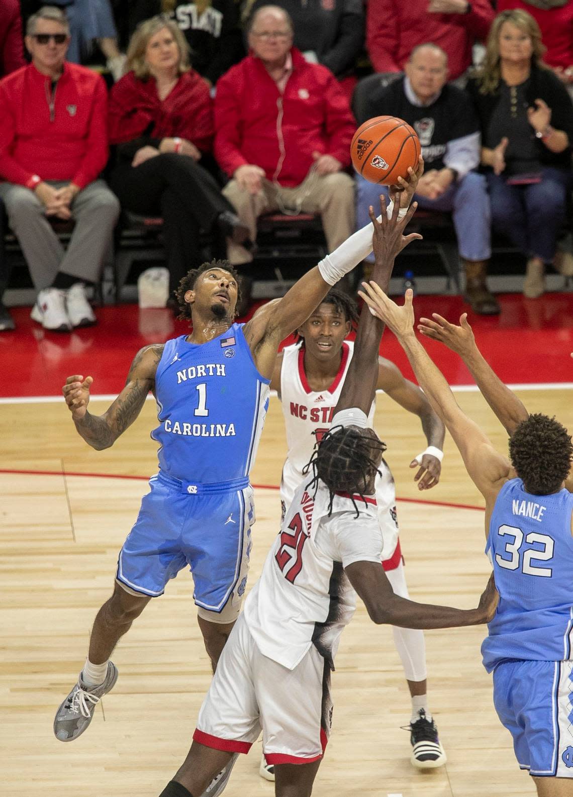 North Carolina’s Leaky Black (1) secures a rebound over N.C. State’s Ebenezer Dowuona (21) during the first half on Sunday, February 19, 2023 at PNC Arena in Raleigh, N.C.