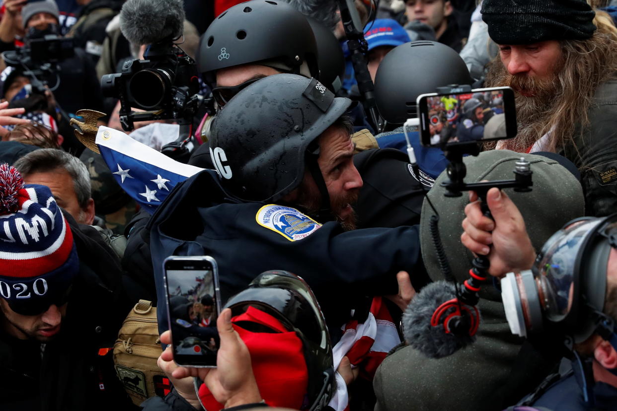 Pro-Trump rioters surround D.C. police officer Michael Fanone at the Capitol on Jan. 6, 2021.