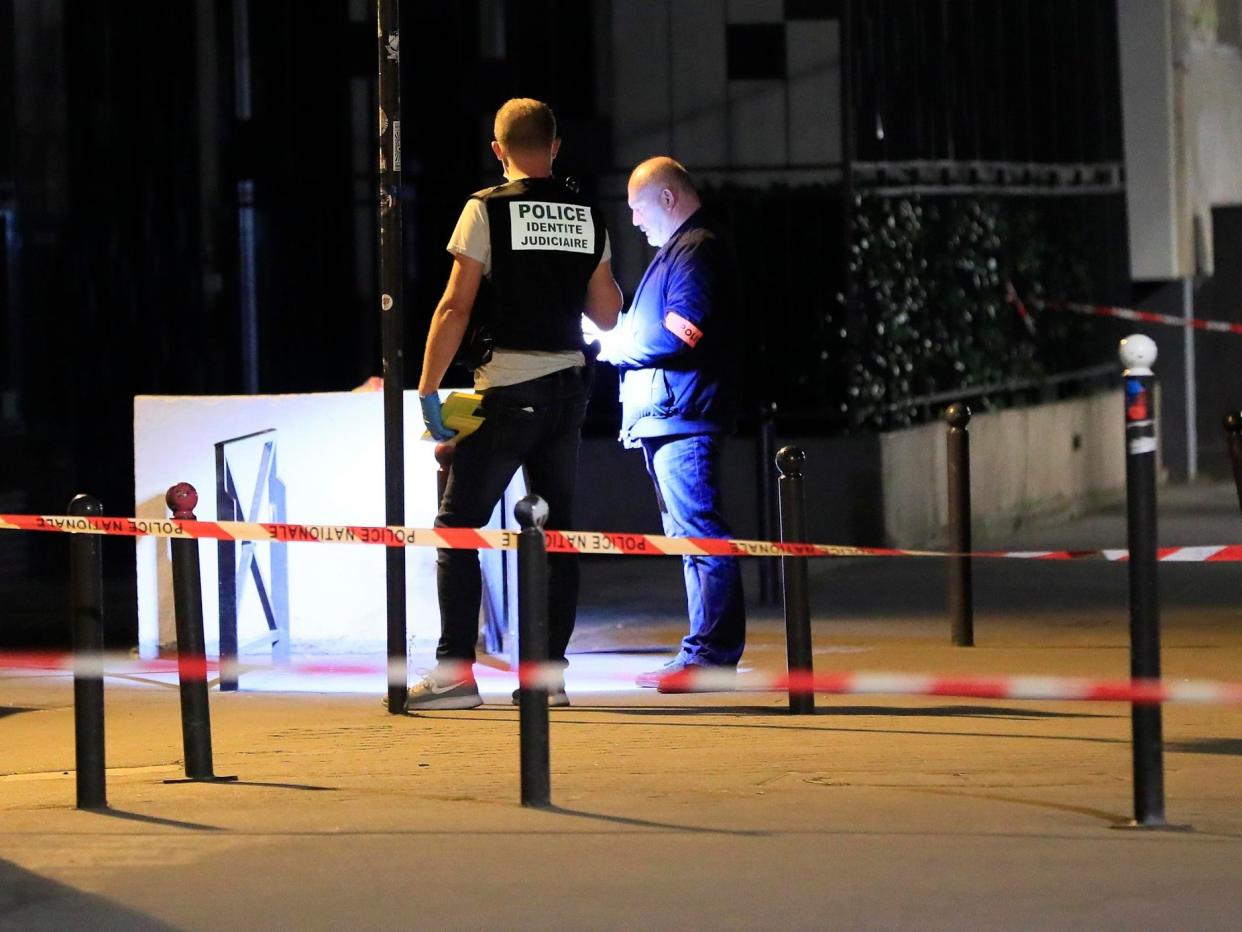 Police investigators work on the scene after seven people were wounded in knife attack in Paris, 10 September: Reuters