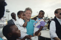 <p>Democratic presidential candidate Bill Clinton is greeted by a pair of young victims of Hurricane Andrew during a visit in Florida City Thursday, Sept. 3, 1992 to the Homestead and Florida City areas where the powerful storm came ashore on August 24. (AP Photo/Lynne Sladky) </p>