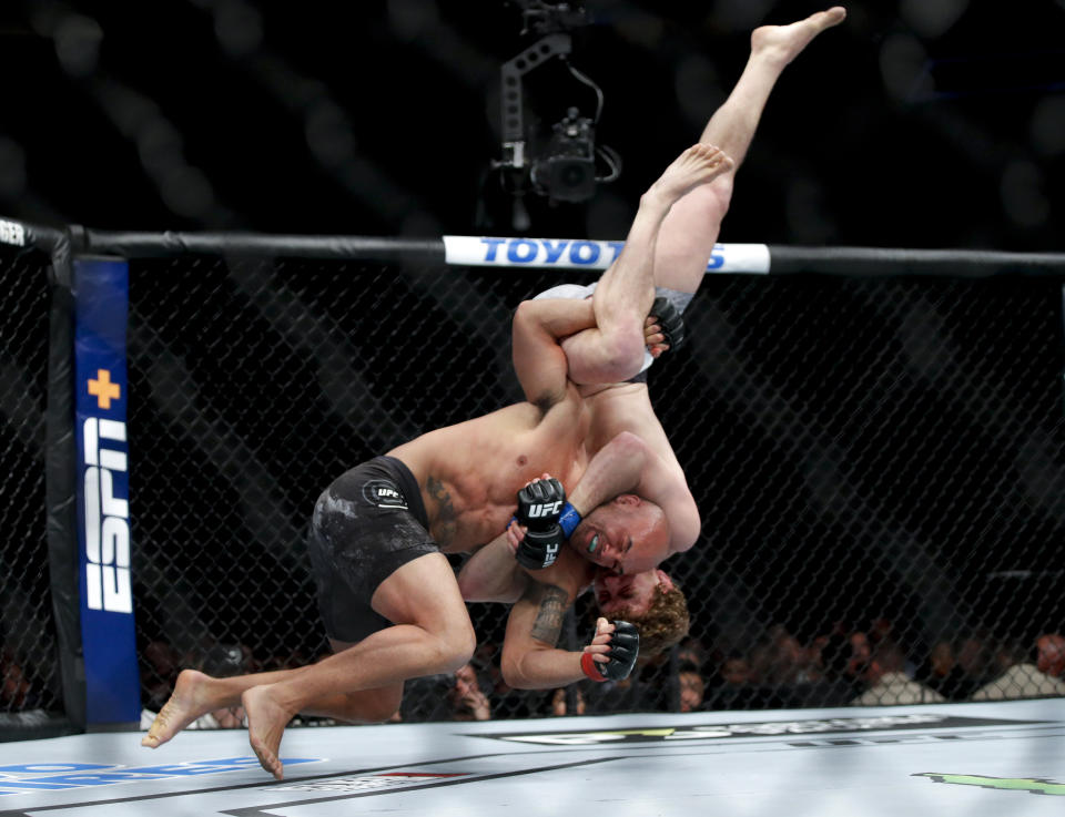 Robbie Lawler, left, fights Ben Askren in a welterweight mixed martial arts bout at UFC 235, Saturday, March 2, 2019, in Las Vegas. (AP Photo/John Locher)