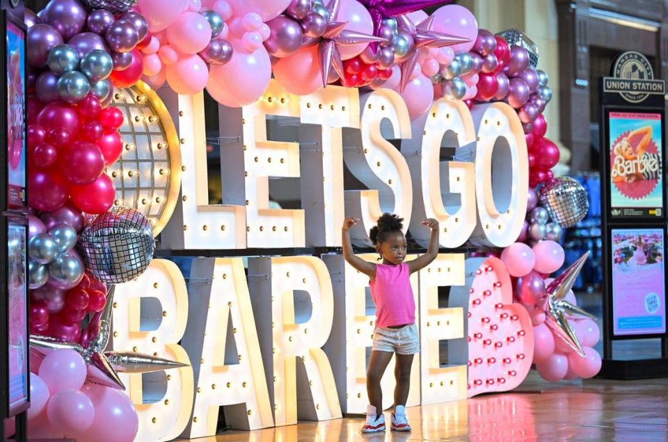 Barbie fans including Amira Sanders, 4, of Kansas City, flocked to Union Station for Barbie-themed photos on Thursday, July 20, 2023, in Kansas City. Amira, who was visiting the display with her mother, Mariea Poole, displayed her girl power for the photo. Tammy Ljungblad/tljungblad@kcstar.com