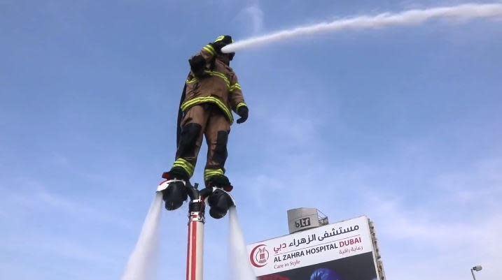 A firefighter using a jetpack tackles a blaze from above (Dubai Civil Defence)