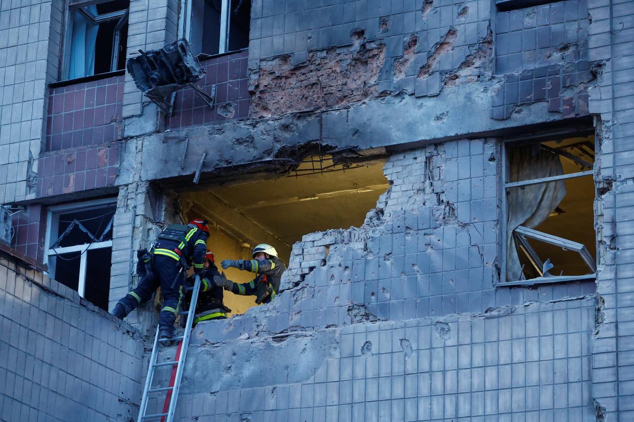 Rescuers work at a site of a building damaged during a Russian suicide drone strike, amid Russia’s attack on Ukraine, in Kyiv, Ukraine 28 May 2023 (Reuters)