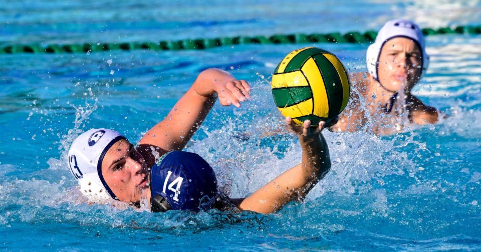 Redwood's Jake Chambers pressures El Diamante's Avery Conway in a league waterpolo match Tuesday, September 27, 2022. 