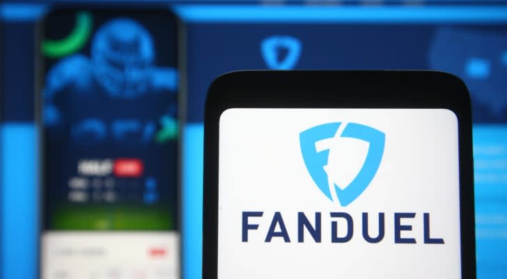 FanDuel logo of a sports betting company is seen on a mobile phone screen in front of FanDuel website on background.