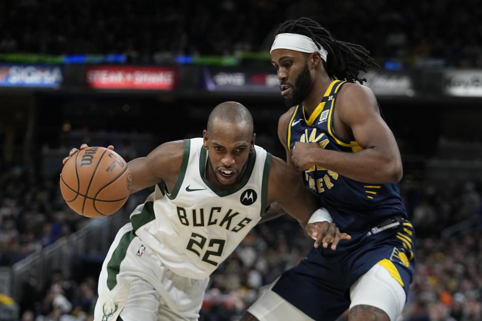 Milwaukee Bucks' Khris Middleton (22) is defended by Indiana Pacers' Isaiah Jackson (22) during the second half of an NBA basketball game, Wednesday, Jan. 3, 2024, in Indianapolis. (AP Photo/Darron Cummings)