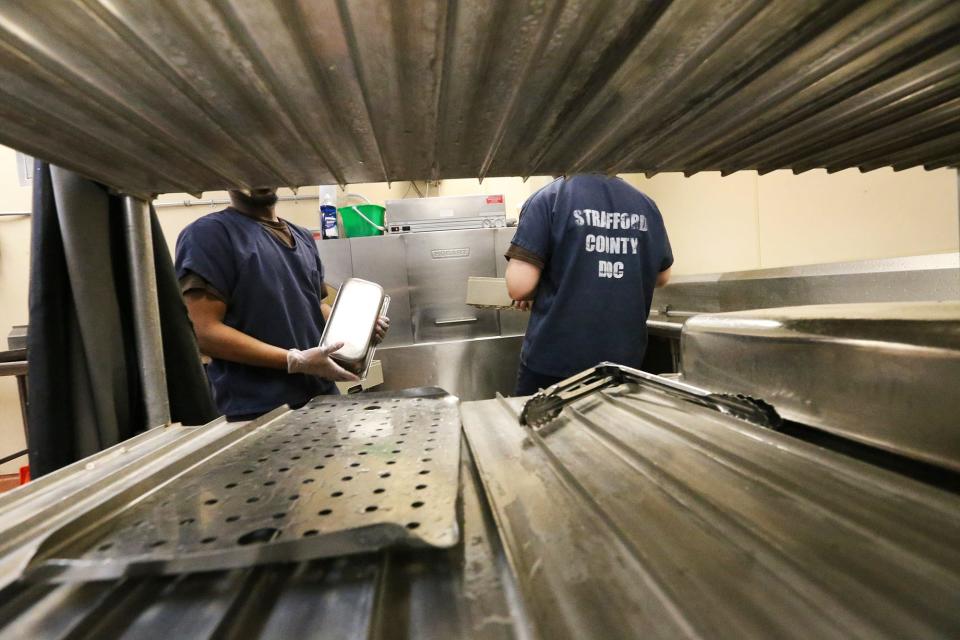 Strafford County Jail inmates clean the kitchen after lunch and work at this as a job they are grateful for in Dover Oct. 26, 2023.