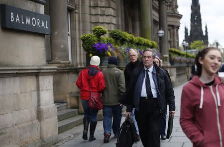 Pedestrians walk past the luxury 5-star Balmoral Hotel in Edinburgh, Scotland May 1, 2014. REUTERS/Suzanne Plunkett