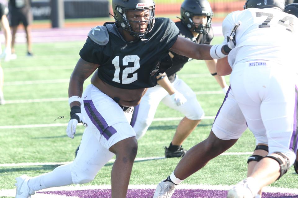 Lipscomb Academy's Tony Carter (12) runs across the line of scrimmage to make a play against teammates in an intrasquad scrimmage during the Lipscomb Academy Showcase on Thursday, May 9, 2024, in Nashville, Tennessee.