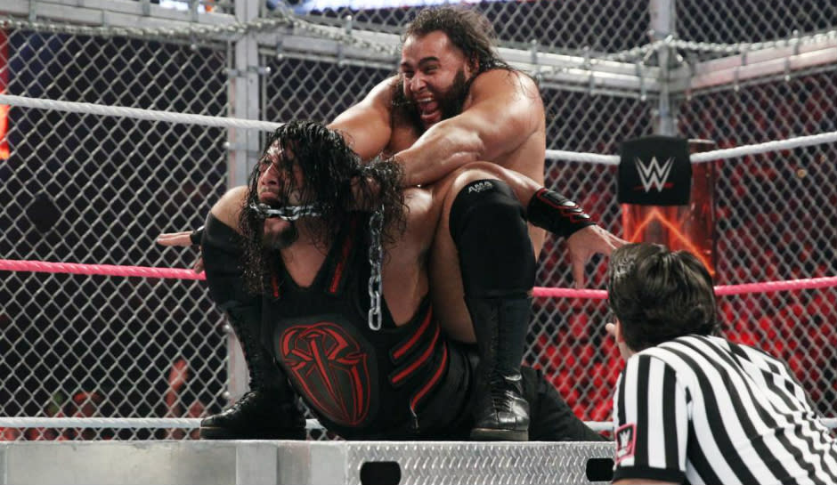 Rusev performs a submission move on Roman Reigns