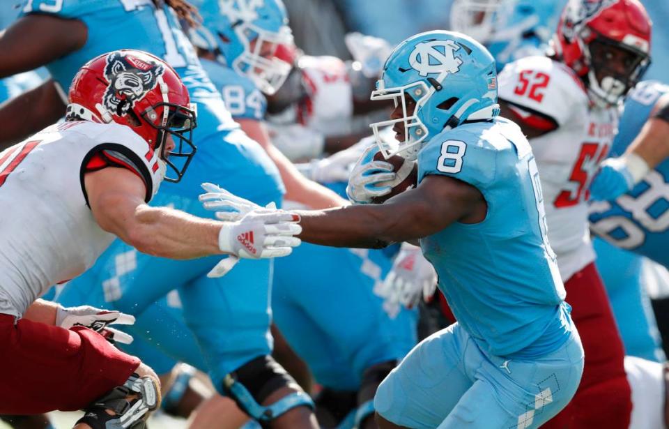 N.C. State linebacker Payton Wilson (11) closes in on North Carolina running back Michael Carter (8) during the second half of UNC’s 48-21 victory over N.C. State at Kenan Stadium in Chapel Hill, N.C., Saturday, Oct. 24, 2020.