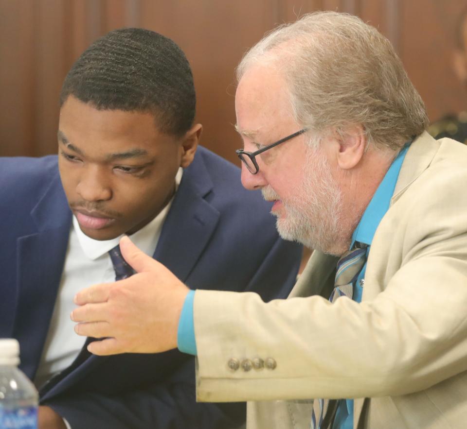 Attorney Pat Summers talks with defendant Christopher Blue on Monday in Summit County Common  Pleas Court.
