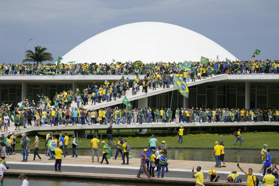 Protesters, supporters of Brazil's former President Jair Bolsonaro, storm the the National Congress building in Brasilia, Brazil, Sunday, Jan. 8, 2023. (AP Photo/Eraldo Peres)