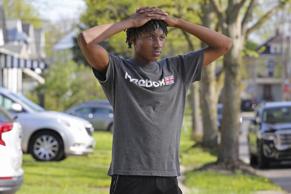 Jamari Shaw, 16, poses for a portrait in his East side neighborhood Thursday, May 11, 2023, in Buffalo, N.Y. Shaw is one of many young people who are still nervous in their surroundings since last years racist mass shooting at Tops Market. (AP Photo/Jeffrey T. Barnes)