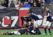 May 12, 2018; Foxborough, MA, USA; New England Revolution forward Cristian Penilla (70) is mobbed by teammates after scoring his second goal during the first half against Toronto FC at Gillette Stadium. Mandatory Credit: Bob DeChiara-USA TODAY Sports