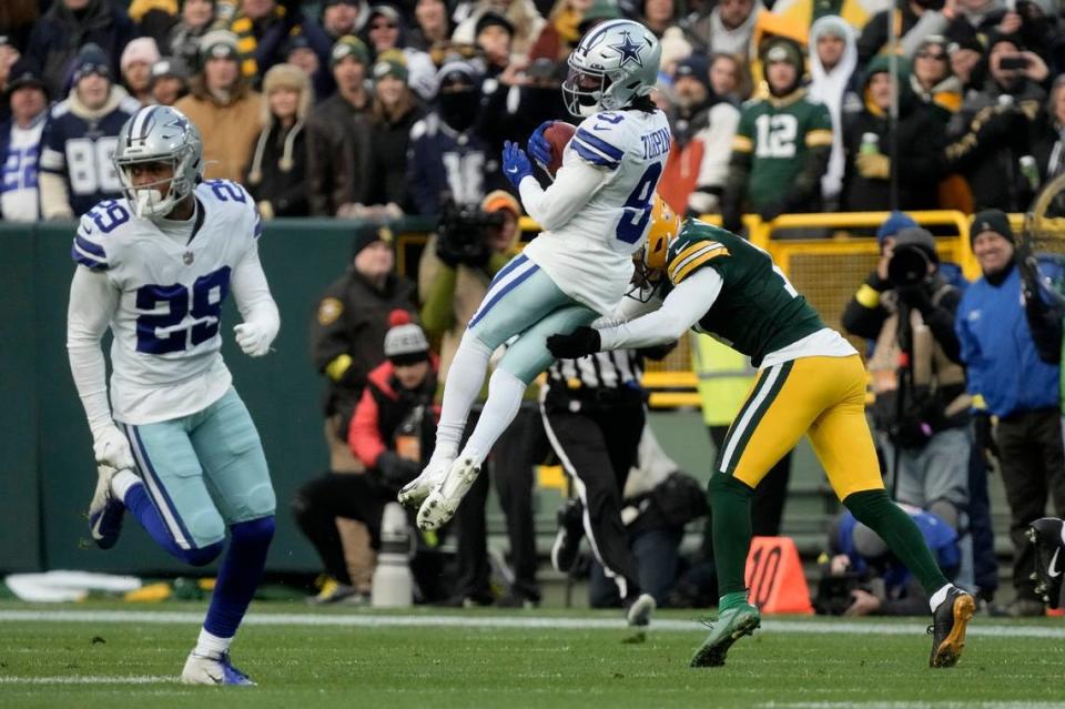 Dallas Cowboys wide receiver KaVontae Turpin (9) is stopped as he returns the ball on the opening kick off by Green Bay Packers place kicker Ramiz Ahmed, right, during Sunday’s game.