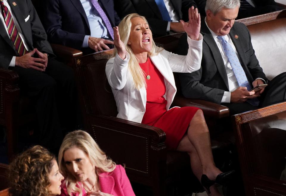 Rep. Marjorie Taylor Greene (R-GA) yells out at House Minority Leader Hakeem Jeffries (D-NY) as Jeffries introduces newly elected Speaker of the House Mike Johnson (R-LA).