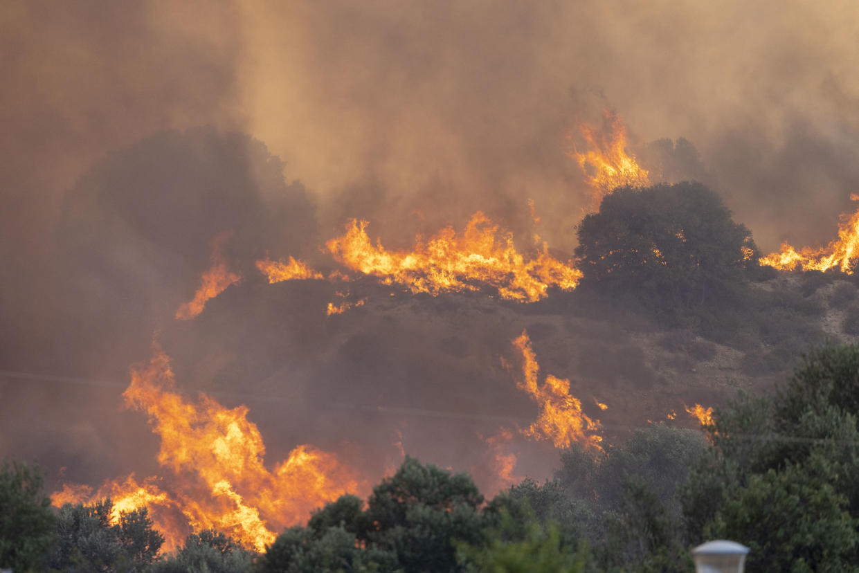 25 July 2023, Greece, Gennadi: At noon a new forest fire broke out near the village of Gennadi, in the evening the flames reach a first settlement, several houses are destroyed. Photo: Christoph Reichwein/dpa (Photo by Christoph Reichwein/picture alliance via Getty Images)