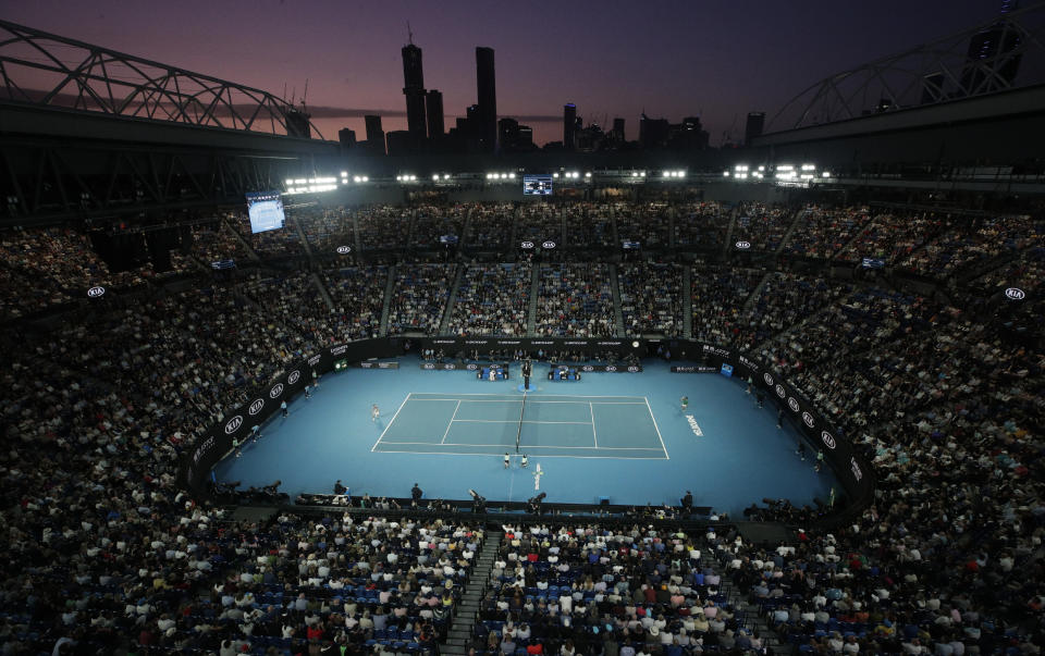 FILE - In this Feb. 2, 2020, file photo, Serbia's Novak Djokovic, right, plays Austria's Dominic Thiem on Rod Laver Arena in the men's singles final at the Australian Open tennis championship in Melbourne, Australia. The political leader of Australia's Victorian state says Wednesday, Nov. 18, 2020, despite "incredibly complex" negotiations, he is confident January's Australian Open tennis tournament will proceed. (AP Photo/Andy Wong, File)