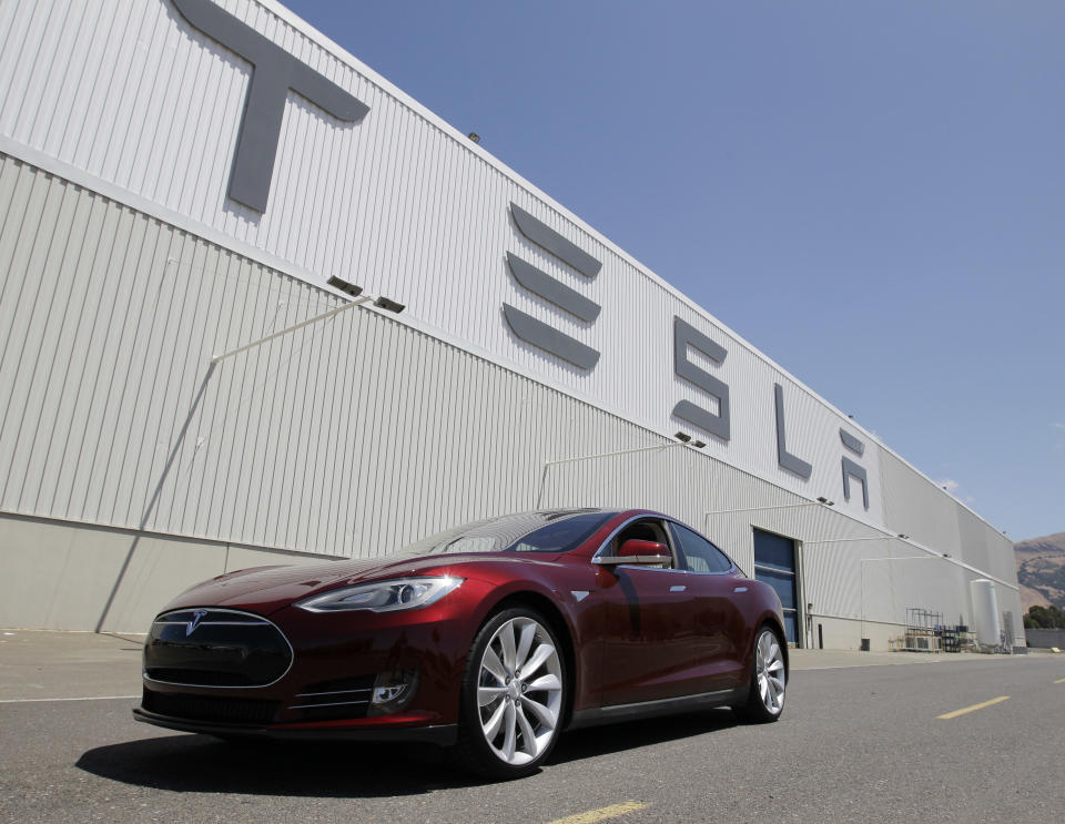 A Tesla Model S drives outside the Tesla factory in Fremont, Calif., Friday, June 22, 2012. The first Model S sedan car will be rolling off the assembly line on Friday. (AP Photo/Paul Sakuma)