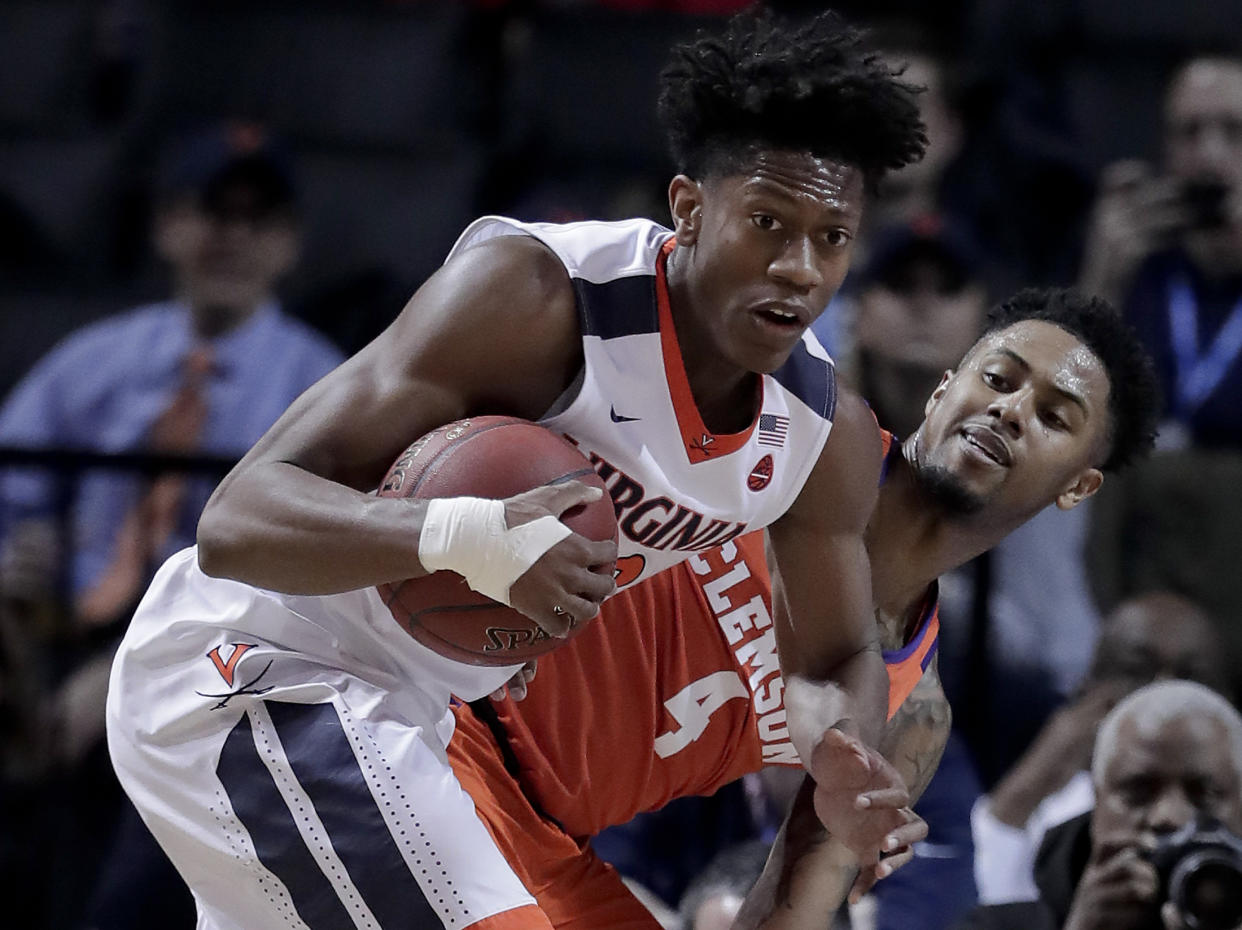 Virginia guard De’Andre Hunter (12) pulls down a rebound next to Clemson guard Shelton Mitchell (4) during the first half of an NCAA college basketball game in the Atlantic Coast Conference men’s tournament semifinals Friday, March 9, 2018, in New York. (AP Photo/Julie Jacobson)