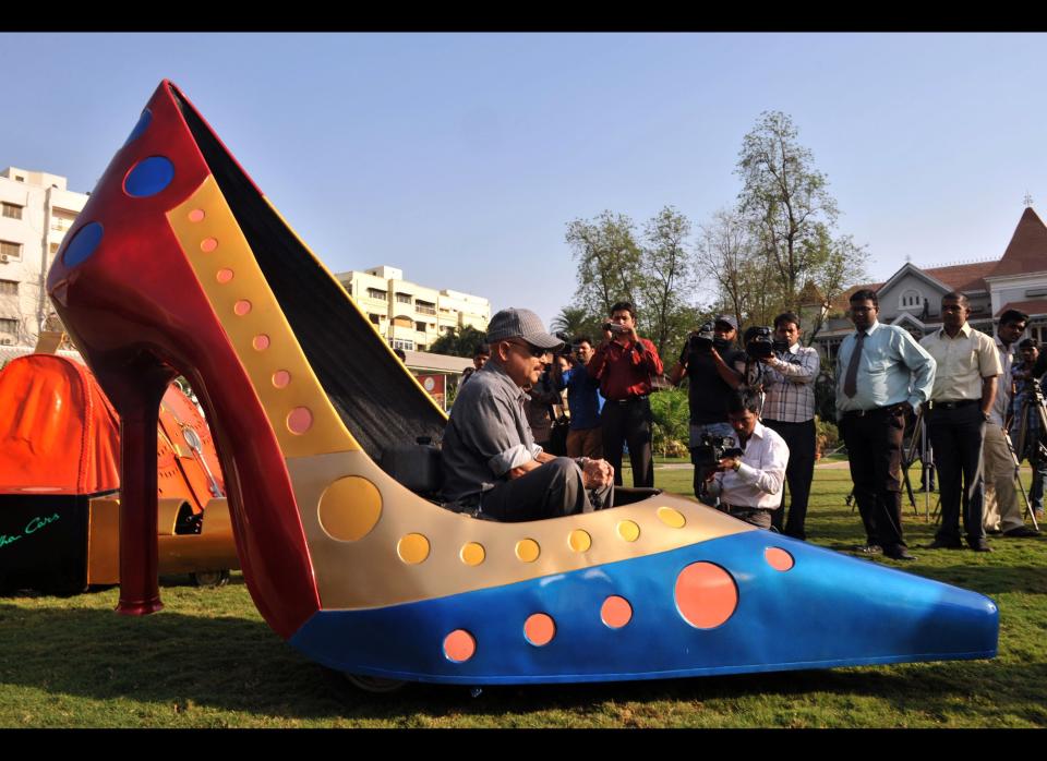 Indian wacky car designer Sudhakar Yadav sits inside a vehicle made in the shape of a stilletto shoe in Hyderabad on March, 7, 2012 on the eve of International Women's Day. International Women's Day originally called International Working Women's Day is a global day, observed annually on March 8, highlighting the economic, political and social achievements of women past, present and future. 