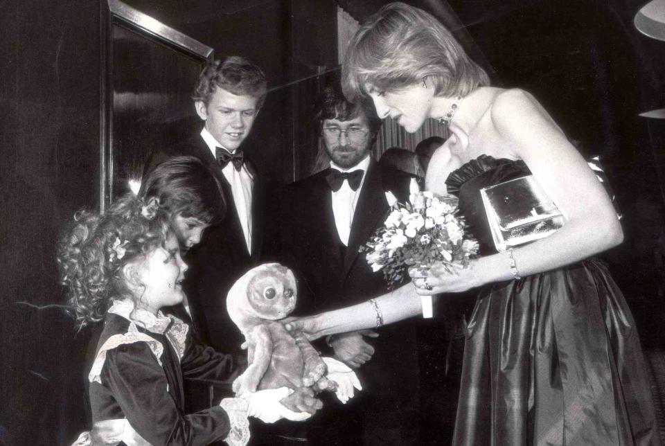 <p>James Gray/Daily Mail/Shutterstock</p> A young Drew Barrymore handed Princess Diana an E.T. doll as Henry Thomas, Robert MacNaughton and Steven Spielberg looked on