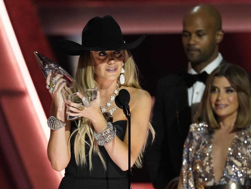 Lainey Wilson accepts the award for album of the year for "Bell Bottom Country" at the 57th Annual CMA Awards on Wednesday, Nov. 8, 2023, at the Bridgestone Arena in Nashville, Tenn. Darius Rucker, center, and Paula Abdul look on from right.(AP Photo/George Walker IV)