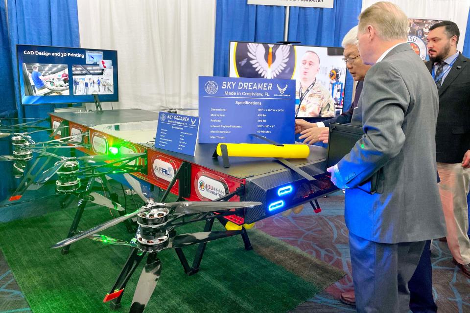 Paul Hsu shows Northwest Florida State College President Devin Stephenson the Sky Dreamer unmanned aerial vehicle, which was built by high school and college students in the Hsu Educational Foundation's UAS Center of Excellence in Crestview. The roughly 8-foot by 10-foot drone can carry a payload of 350 pounds for up to one hour. The drone was on display Tuesday at the TeCMEN Industry Day at the Destin-Fort Walton Beach Convention Center on Okaloosa Island.