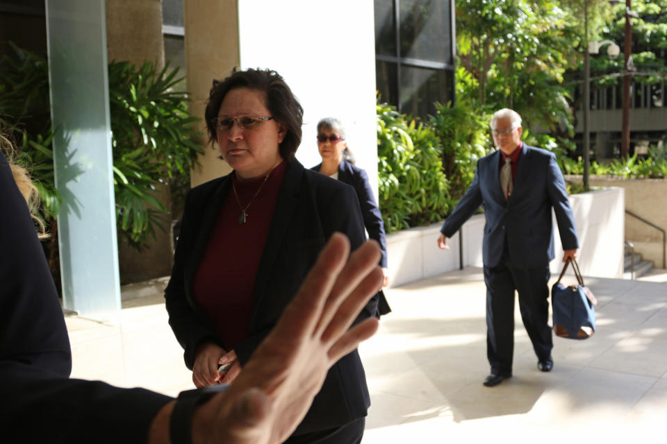 FILE - In this May 22, 2019, file photo, former Honolulu deputy city prosecutor Katherine Kealoha, left, and her husband, ex-police chief Louis Kealoha, right, walk into federal court in Honolulu. Closing arguments are set for Tuesday, June 25, 2019, in a trial for that's been described as Hawaii's biggest public corruption case. Former Honolulu deputy prosecutor Katherine Kealoha and her retired police chief husband, Louis Kealoha, are on trial with current and former officers. Prosecutors say the Kealoha's conspired with officers in a secret police unit to frame Katherine Kealoha's uncle to keep him from revealing fraud that financed the couple's lavish lifestyle. (AP Photo/Caleb Jones, File)