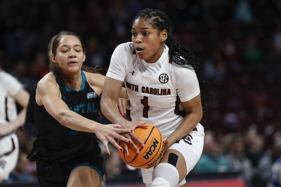 Coastal Carolina guard Deaja Richardson, left, strips the ball from South Carolina guard Zia Cooke during the first half of an NCAA college basketball game in Columbia, S.C., Wednesday, Dec. 21, 2022. (AP Photo/Nell Redmond)