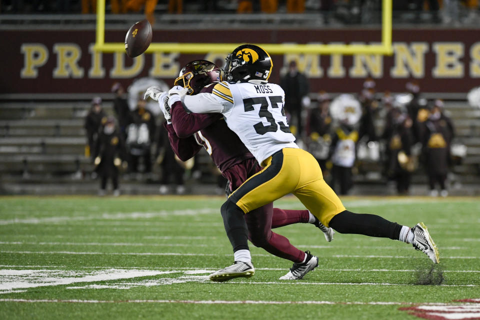 Iowa Hawkeyes defensive back Riley Moss (33) deflects a pass intended for Minnesota wide receiver Le'Meke Brockington (0) during the second half an NCAA college football game on Saturday, Nov. 19, 2022, in Minneapolis. The deflection resulted in an interception. (AP Photo/Craig Lassig)