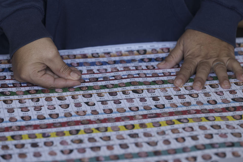 A electoral volunteer counts ballots at a polling station during general elections in Tegucigalpa, Honduras, Sunday, Nov. 28, 2021. (AP Photo/Moises Castillo)