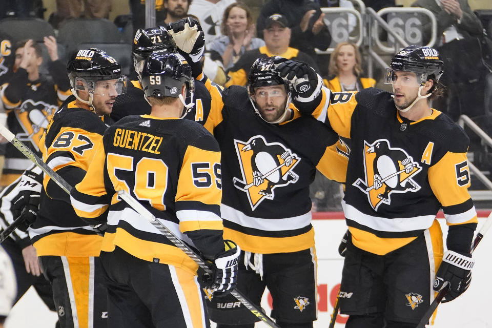 Pittsburgh Penguins' Bryan Rust (17) celebrates his goal during the second period of an NHL hockey game against the Arizona Coyotes in Pittsburgh, Tuesday, Jan. 25, 2022. (AP Photo/Gene J. Puskar)