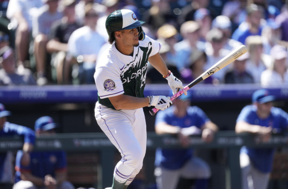 Colorado Rockies' Ezequiel Tovar follows the flight of his RBI single against Chicago Cubs starting pitcher Jameson Taillon in the fourth inning of a baseball game Wednesday, Sept. 13, 2023, in Denver. (AP Photo/David Zalubowski)