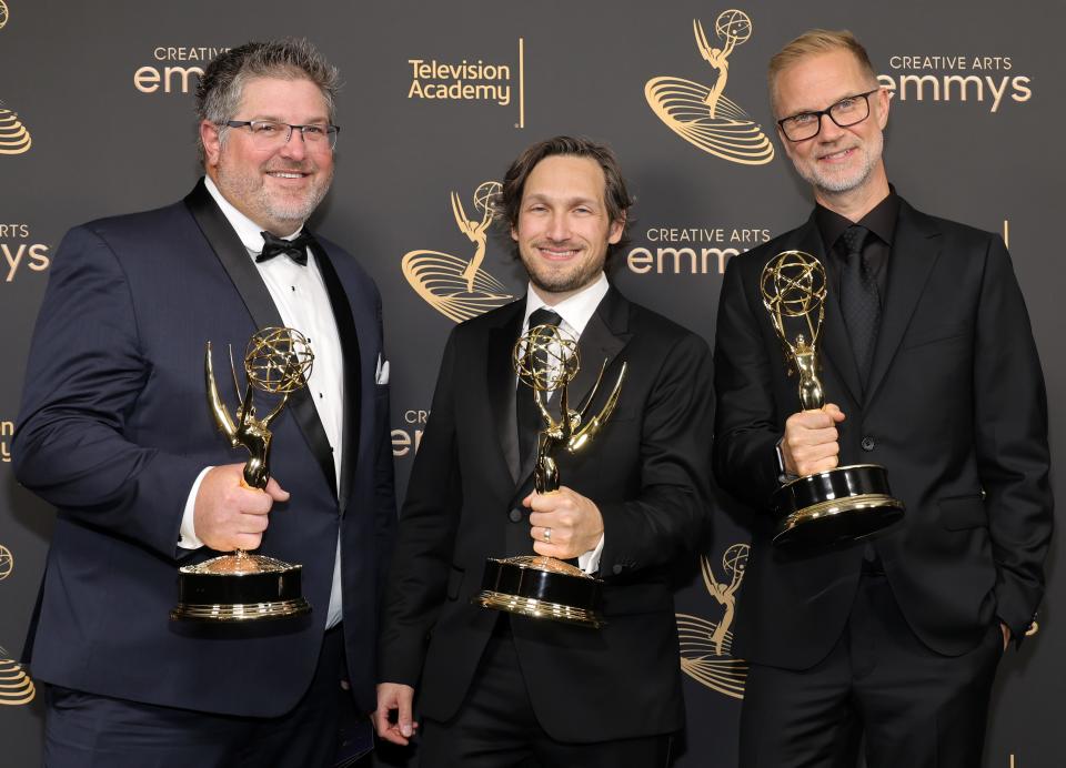 Noah Mitz (center, with Matthew Cotter and Bryan Klunder) shows off his Emmy after winning for outstanding lighting design/lighting direction for a variety special for "Adele: One Night Only" at the 2022 Creative Arts Emmys in Los Angeles Sept. 3, 2022. For Mitz, a Milwaukee native who went to Nicolet High School, it was his first Emmy win in 23 nominations, including five at this year's Emmys.