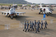 Chinese Air Force personnel march past the Chinese military's J10C fighter and JH-7A2 fighter bomber during 13th China International Aviation and Aerospace Exhibition, also known as Airshow China 2021, Wednesday, Sept. 29, 2021, in Zhuhai in southern China's Guangdong province. With record numbers of military flights near Taiwan over the last week, China has been stepping up its harassment of the island it claims as its own, showing an new intensity and sophistication as it asserts its territorial claims in the region. (AP Photo/Ng Han Guan)