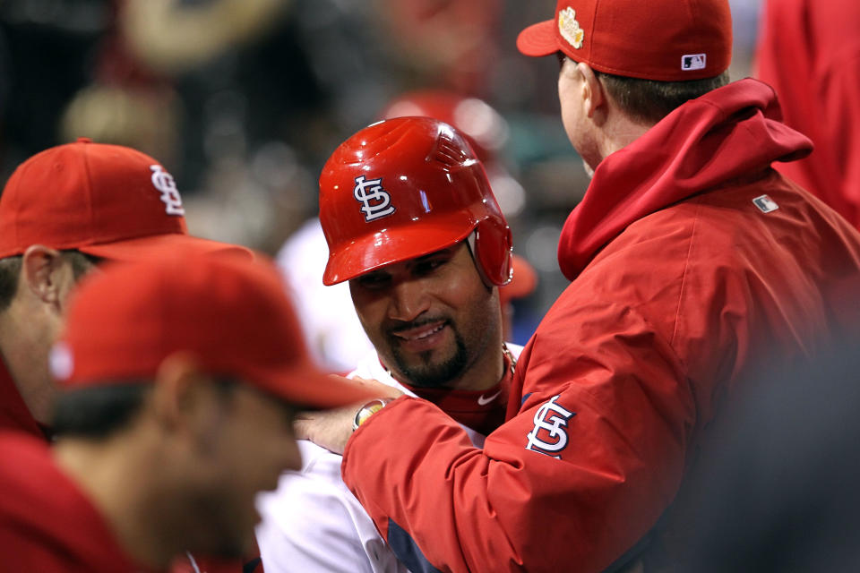 ST LOUIS, MO - OCTOBER 28: Albert Pujols #5 of the St. Louis Cardinals celebrates in the dugout after scoring on a Rafael Furcal #15 hit by pitch with the bases loaded in the fifth inning during Game Seven of the MLB World Series at Busch Stadium on October 28, 2011 in St Louis, Missouri. (Photo by Jamie Squire/Getty Images)