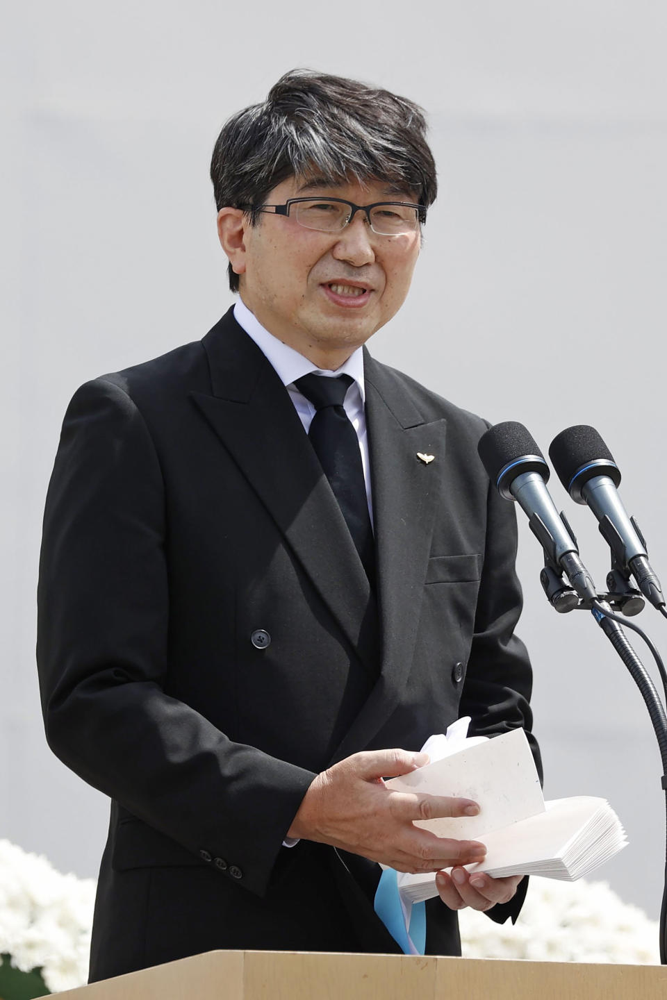 Nagasaki Mayor Tomihisa Taue delivers a speech during a ceremony to mark the 77th anniversary of the U.S. atomic bombing at the Peace Park in Nagasaki, southern Japan, Tuesday, Aug. 9, 2022. (Kyodo News via AP)