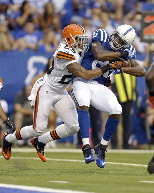 Cleveland Browns cornerback Joe Haden, left, tackles Indianapolis Colts wide receiver Darrius Heyward-Bey during the first half of a preseason NFL football game in Indianapolis, Saturday, Aug. 24, 2013. (AP Photo/Jeff Roberson)