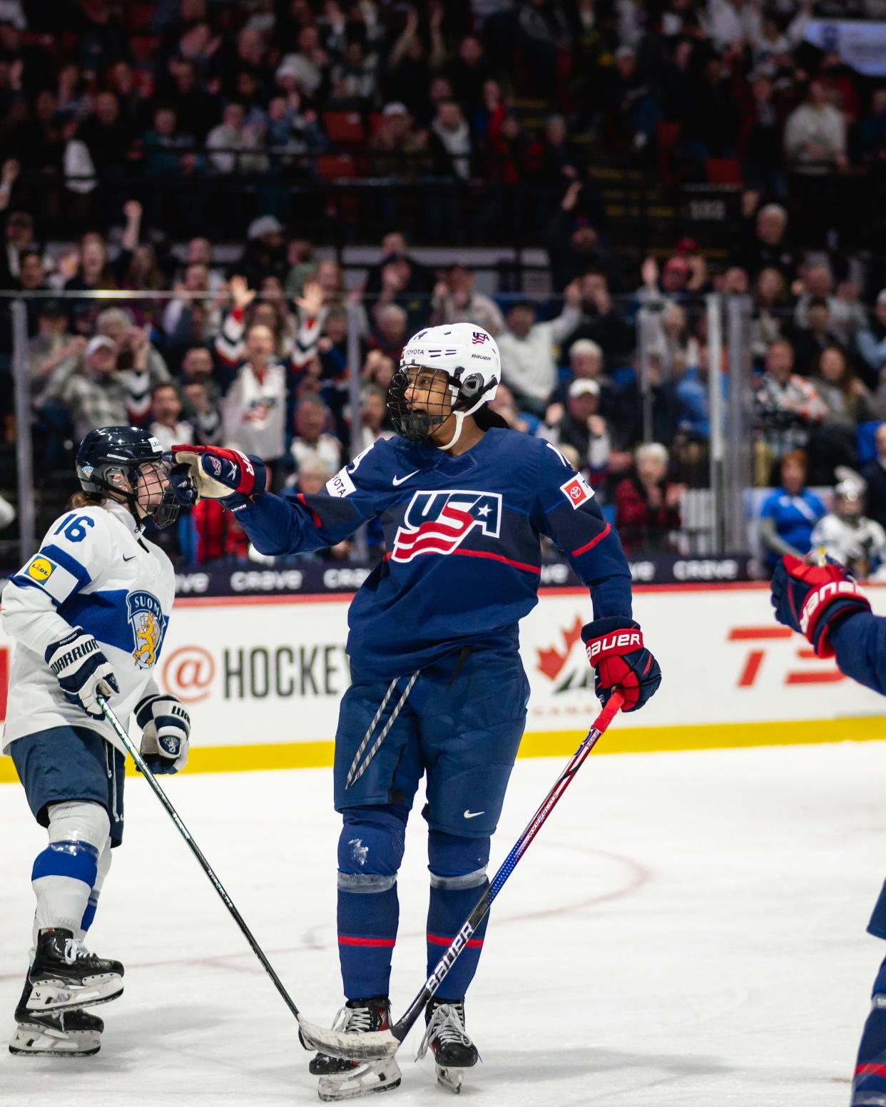 Team USA forward Laila Edwards, a sophomore at Wisconsin, points towards a teammate after scoring a hat-trick against Finland in the semifinals of the women’s hockey world championships Saturday in Utica, N.Y.